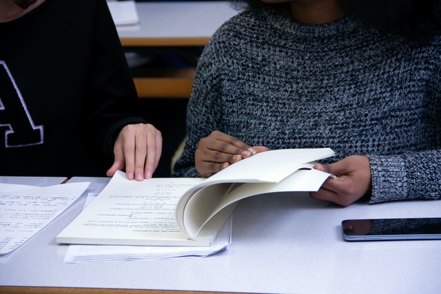 two women with a book learning how does anxiety affect test taking