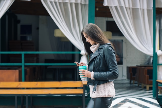 young adult woman looking at her cell phone because she is nervous dating