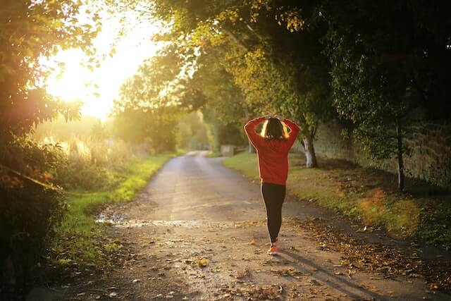 girl walking in the park practicing a stress management plan to reduce anxiety