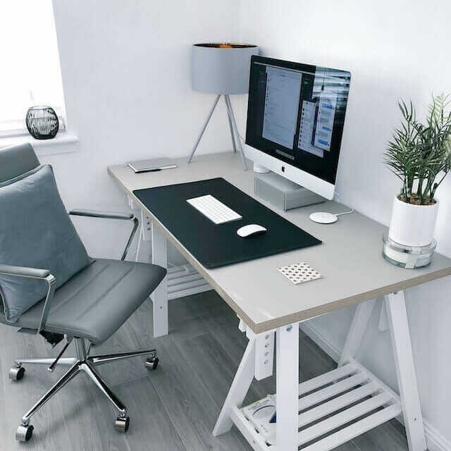 Organized work desk with computer and chair to help on how to stop procrastinating working from home