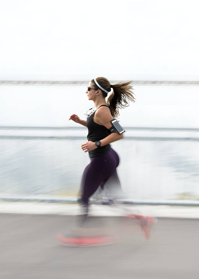 A young adult woman running outside could be part of anxiety habits to avoid